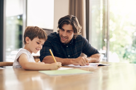 father helping son with homework